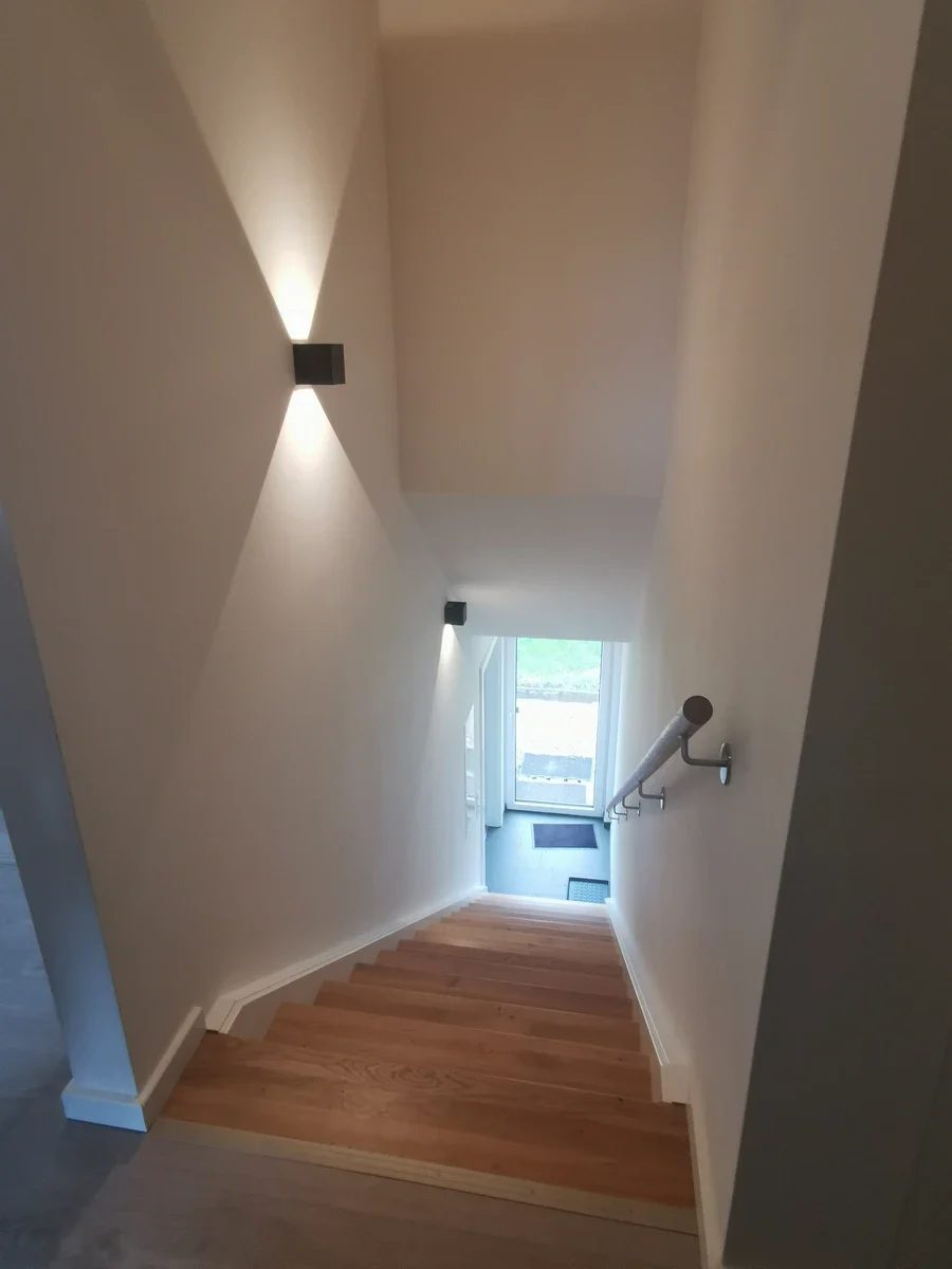 Ausgebauter Flur mit Holztreppe im neuen Anbau